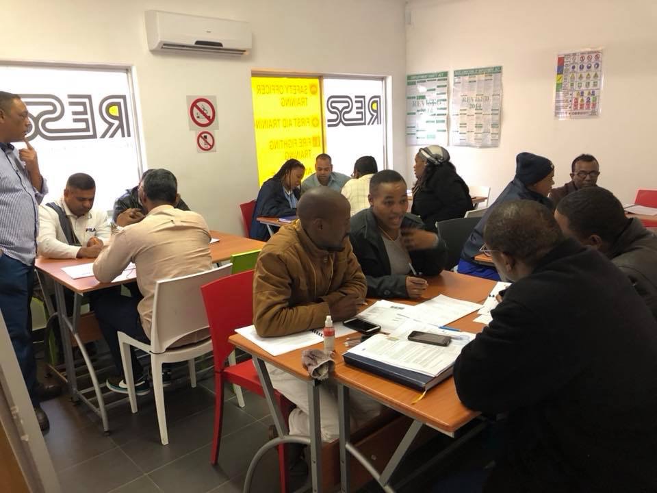 Learners in a RESS branded training room working through safety officer coursework