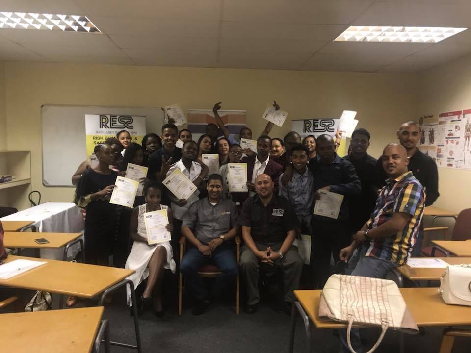 Delegates holding up their certificates after completing a RESS course