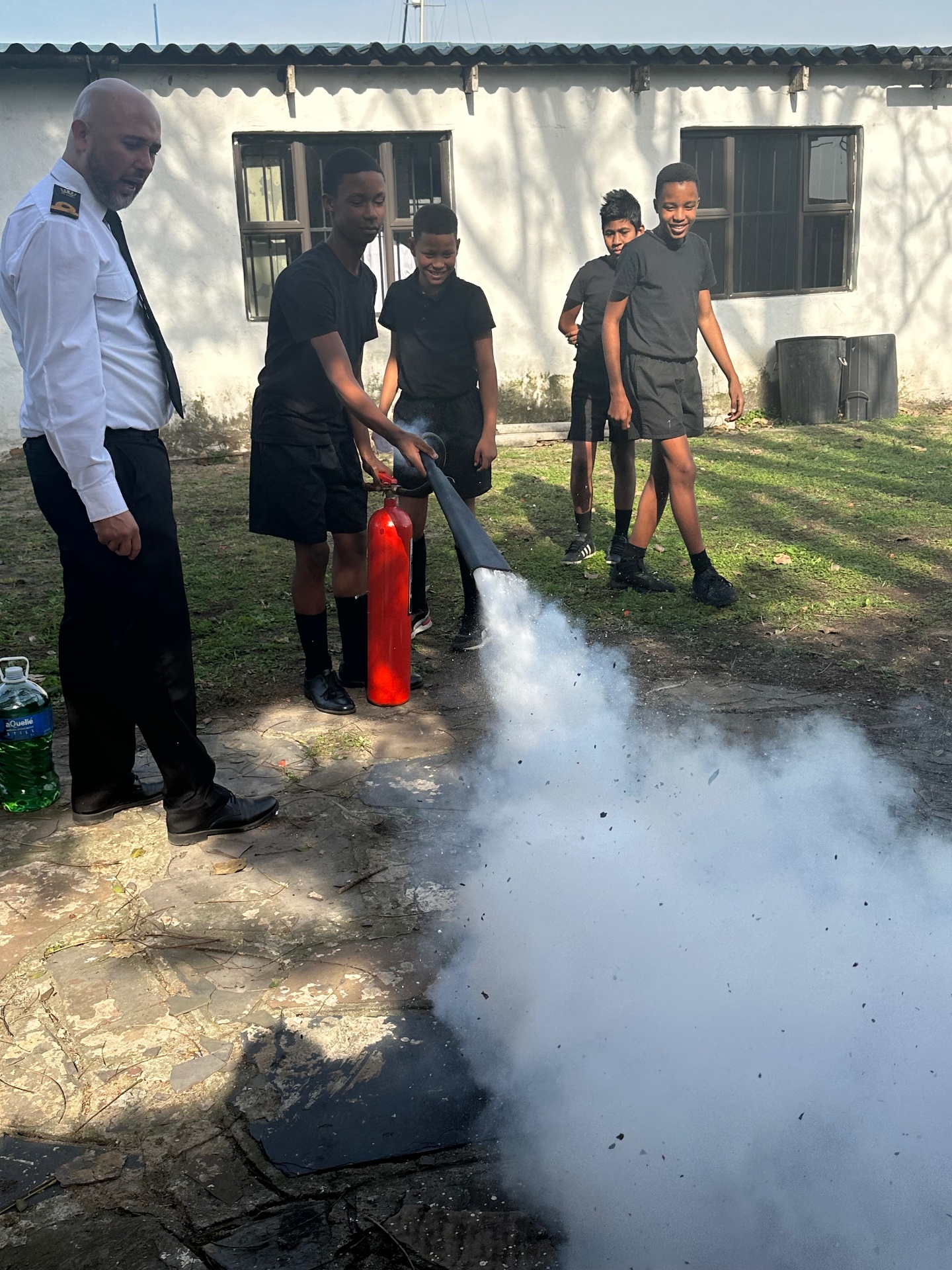 RESS instructor running a practical fire-extinguisher exercise with learners